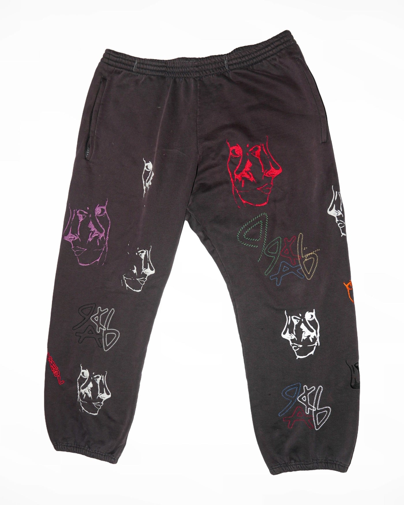 ABnormal Gallery black sweatpants with multicolored embroidered face motifs and glow-in-the-dark details